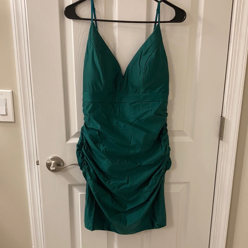 Emerald green figure flatting dress with ruching.
